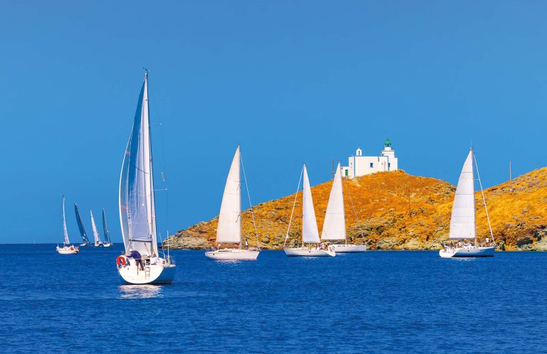 Sailing boats passing by Aghios Nikolaos cape on Kea during a regatta