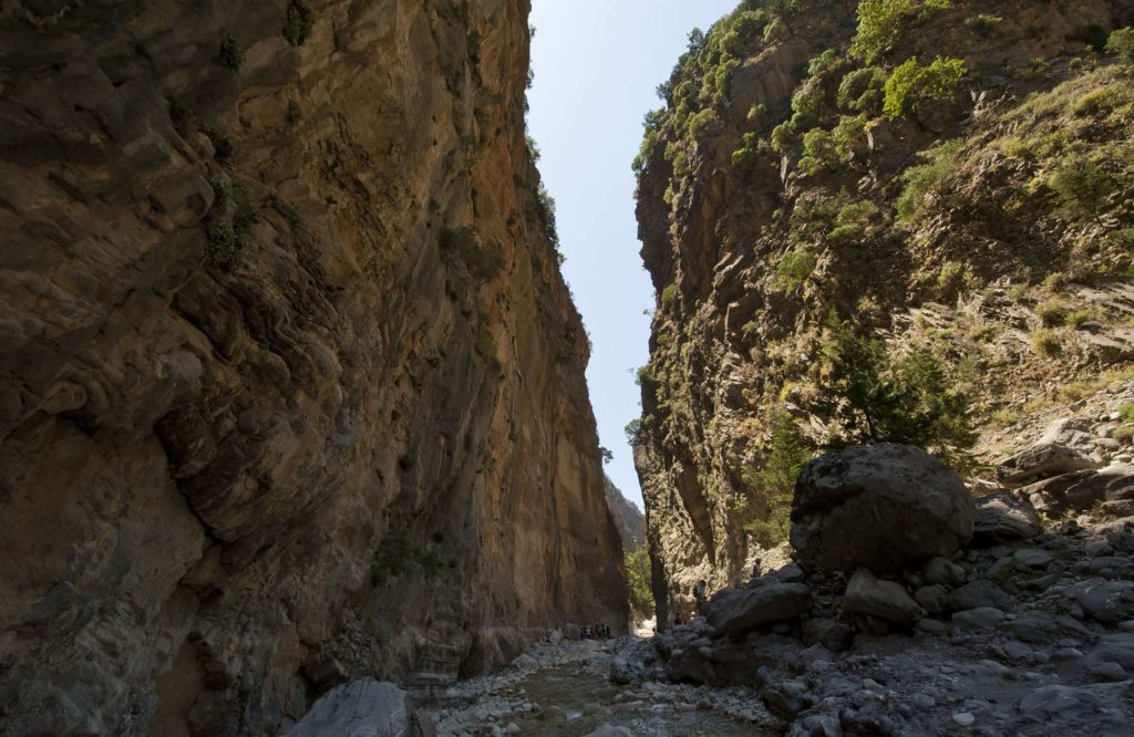 Narrow passage between two tall vertical rock walls