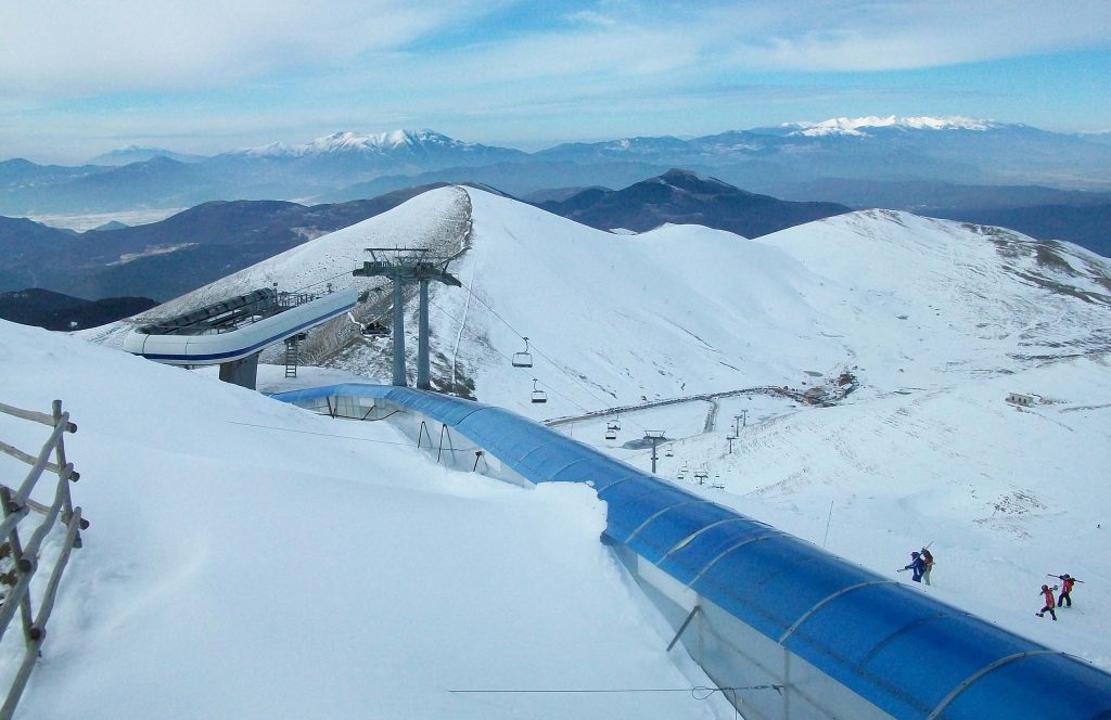 Snow-covered ski slopes and lift equipment at the ski resort on Mount Falakro.